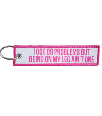 I got 99 problems keychain in hot pink text against a creme background