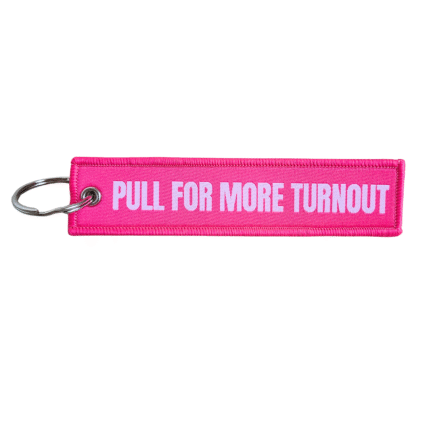 hot pink keychain that reads "Pull For More Turnout"