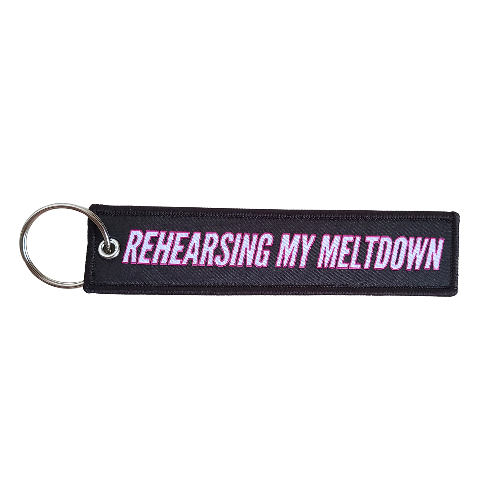 RMM Rehearsing My Meltdown keychain in white text with pink bordering against a black background